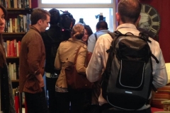 Difficult to see the dresses in a small shop, filled with press people